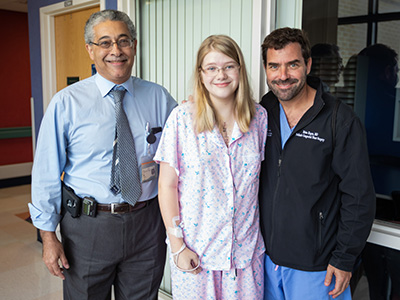 Bailey Sanderford smiles with her cardiologist Dr. Makram Ebeid, left, and her surgeon, Dr. Brian Kogon, just days after a successful heart surgery. Ebeid has cared for Bailey since she was a baby.